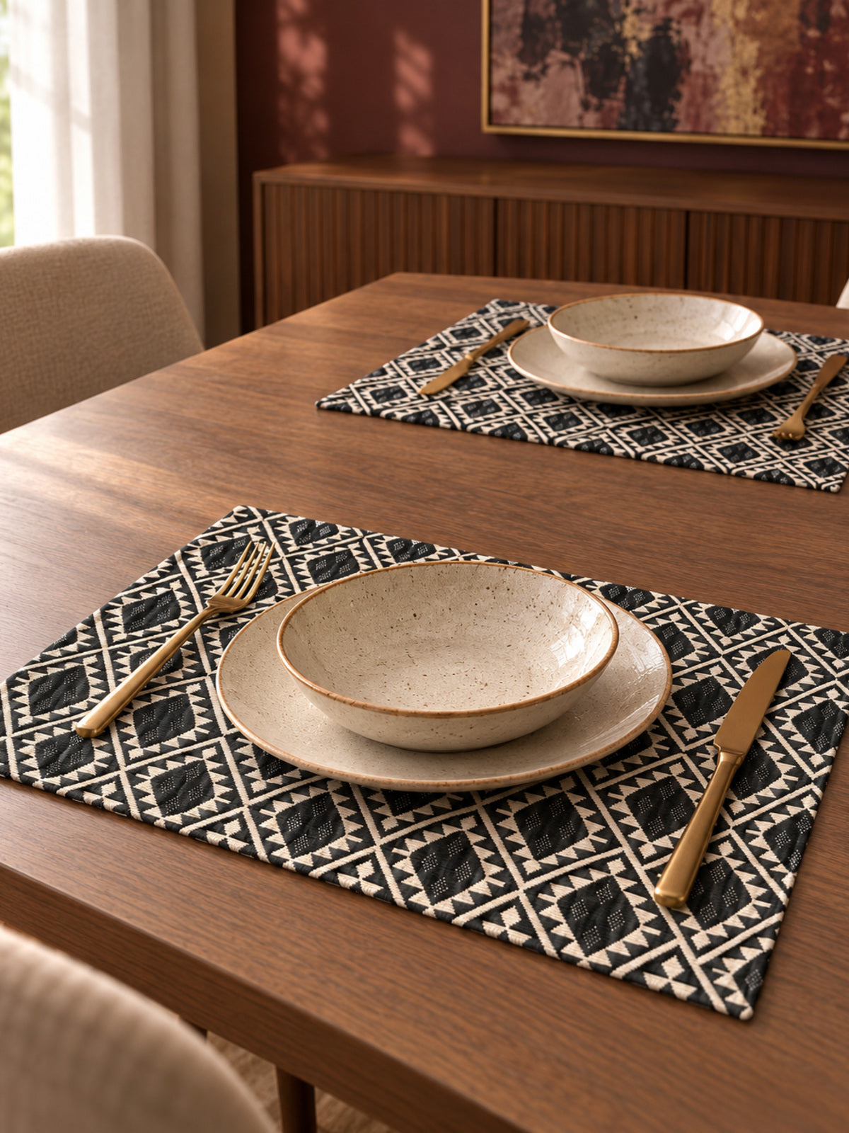 Nomad black and ivory geometric jacquard placemats styled on a modern dining table