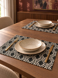 Nomad black and ivory geometric jacquard placemats styled on a modern dining table