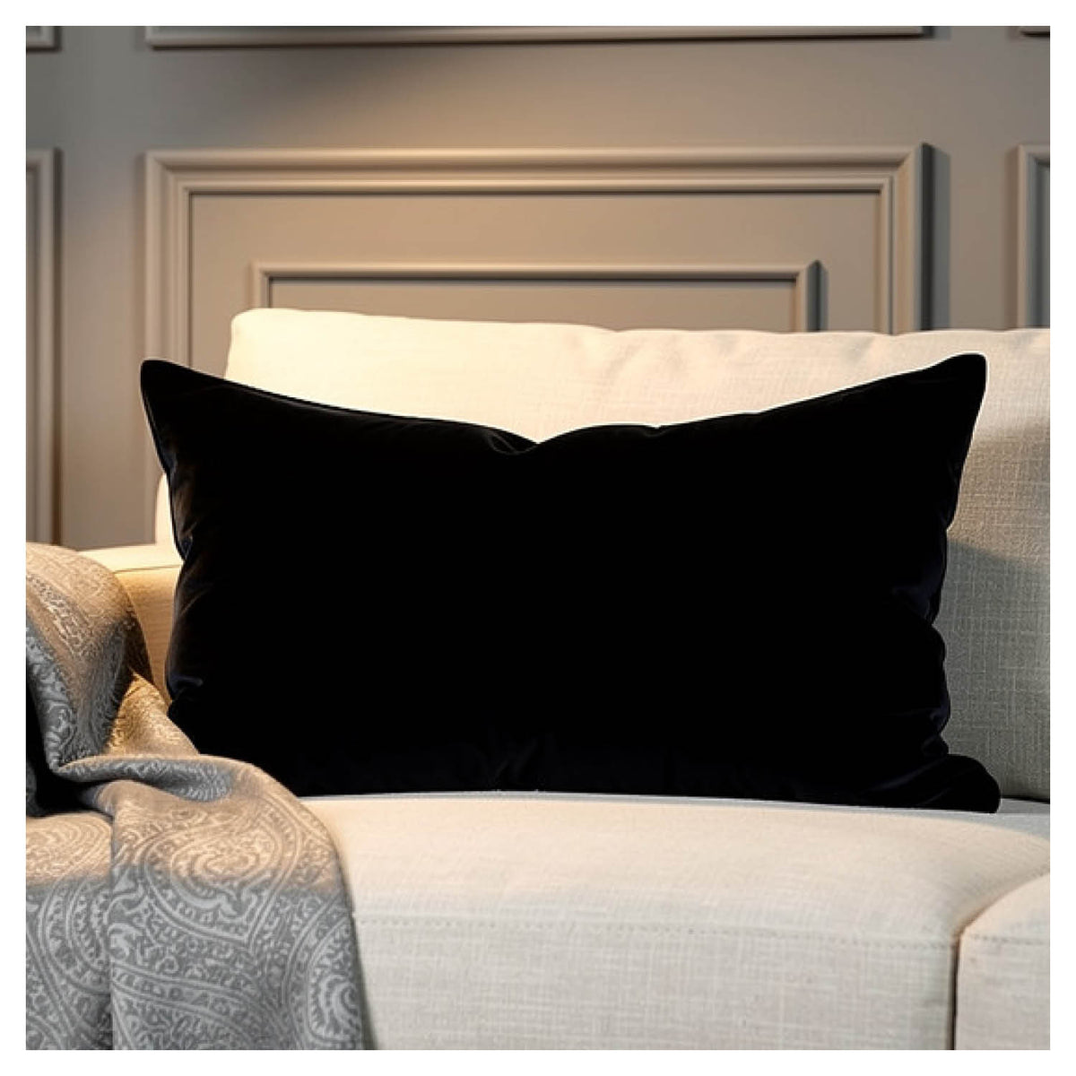 Black velvet lumbar pillow styled on a light coloured sofa