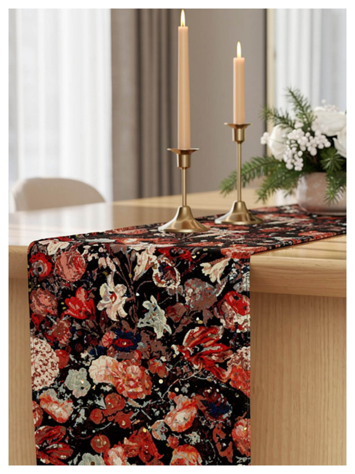 Floral patterned table runner on a wooden table with candles and flowers.