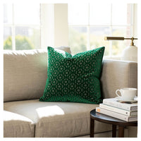 emerald green geometric patterned velvet cushion styled on sofa