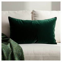 Forest green velvet lumbar pillow styled on a sofa
