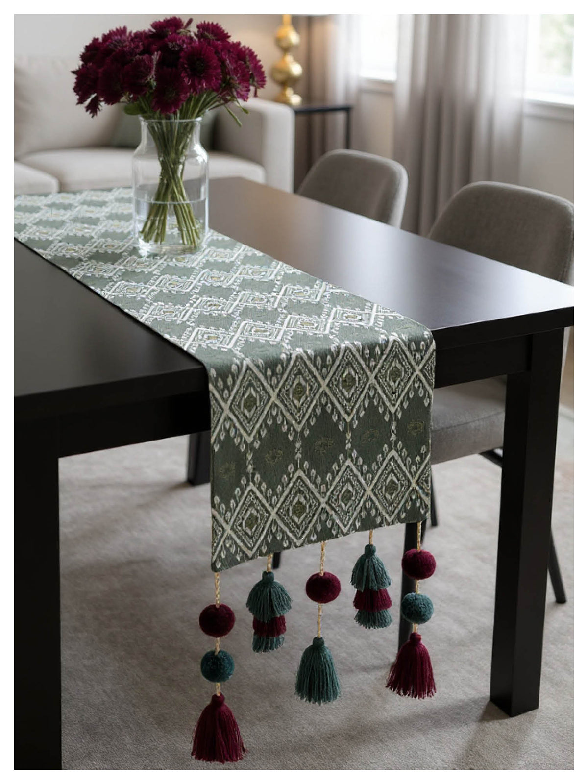 Decorative table runner with tassels on a dining table in a home setting.