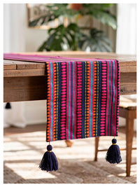 Navy and hot pink tasseled table runner styled on a dining table