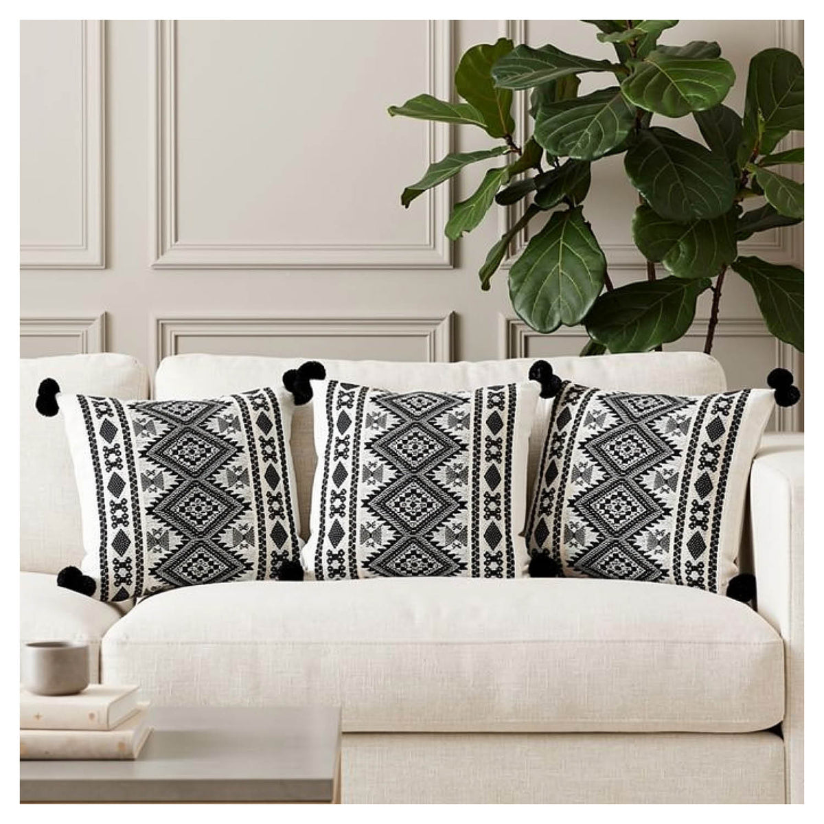 Aztec border cushion set of six with pom-pom edging styled on a monochrome sofa