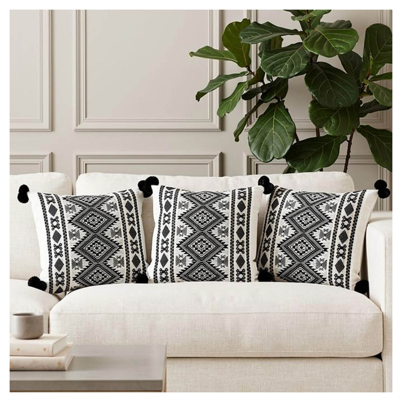 Aztec border cushion set of six with pom-pom edging styled on a monochrome sofa