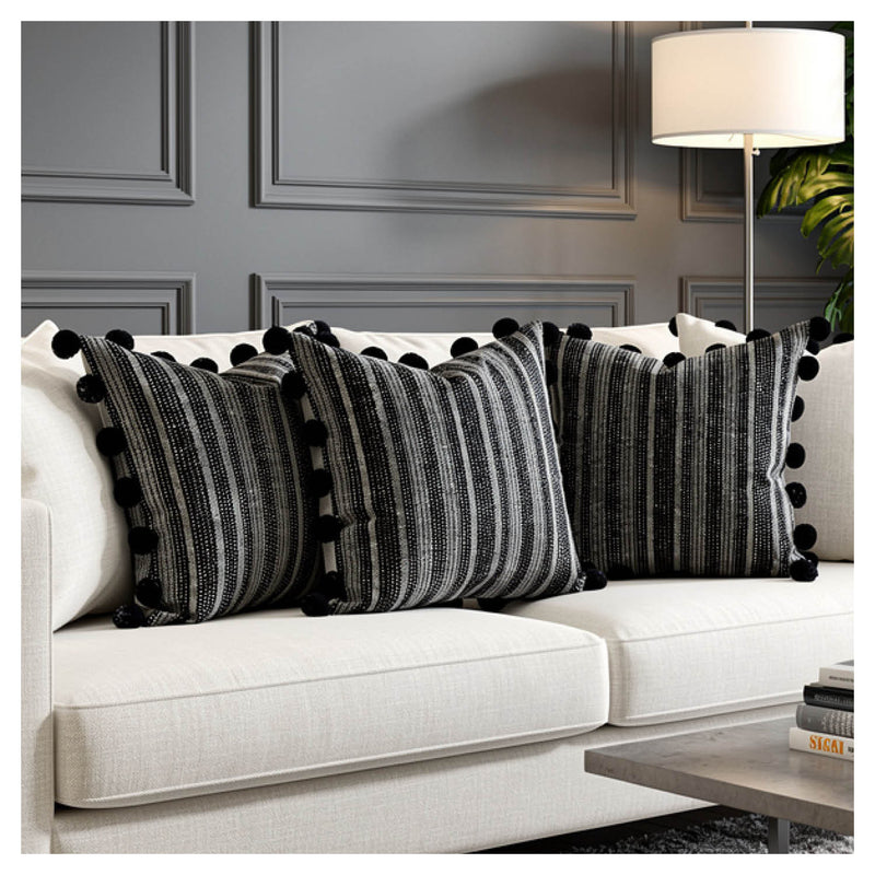 Midnight black pommed cushion set of six with subtle sheen styled on a monochrome sofa