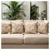 Beige paisley jacquard cushion set of six with tassel detailing styled on a sofa