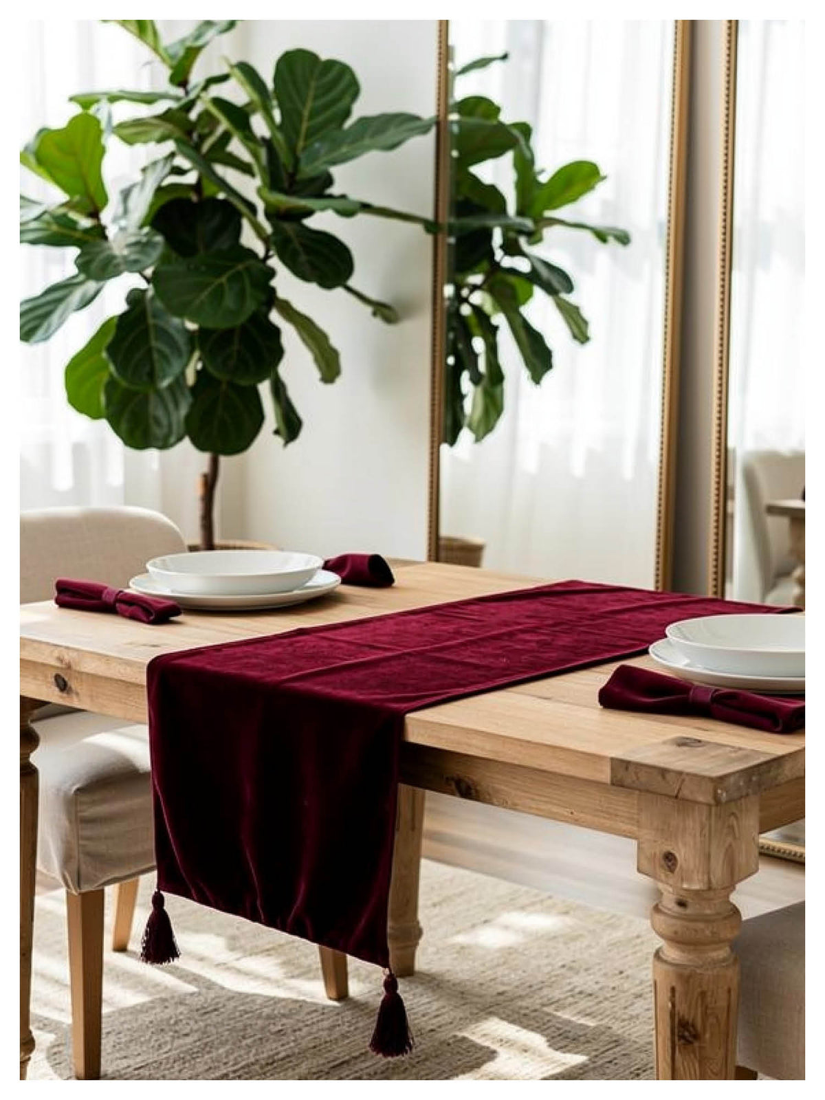 Ruby velvet table runner styled on a dining table with minimal tableware