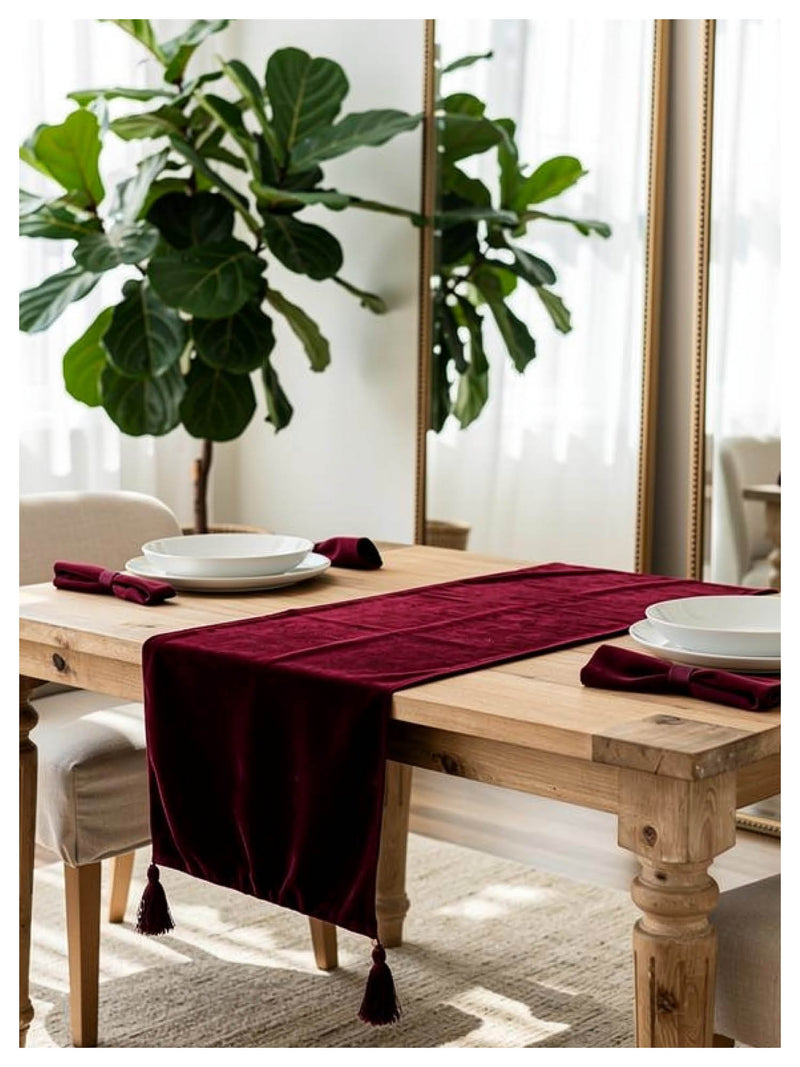 Ruby velvet table runner styled on a dining table with minimal tableware