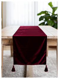 Ruby velvet table runner styled on a dining table